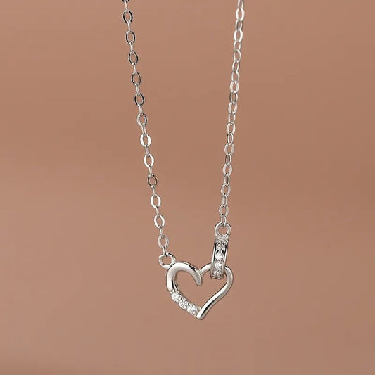 Disfruta la elegancia de estajoya de plata18K bañada en oro de 925. Diseño de círculos entrelazados con corazón de zirconia blanca, ideal para un look con estilo. - Aurora Boré
